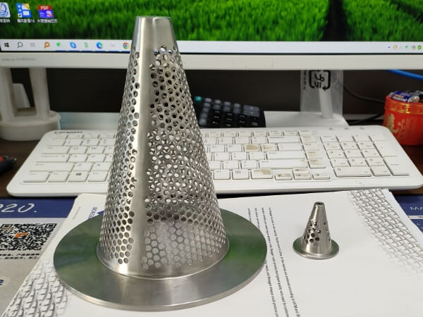 A big and a small conical perforated filter elements