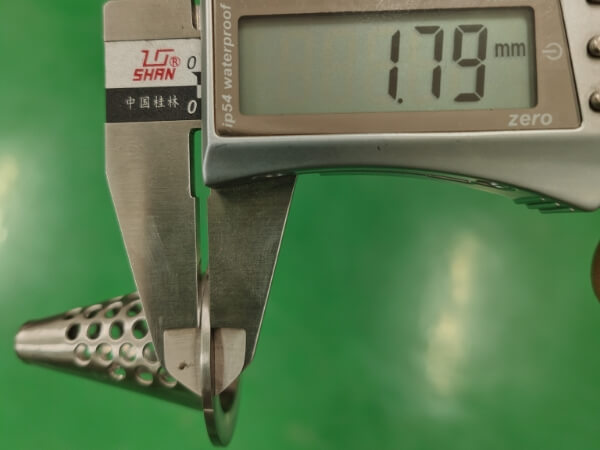 The flange thickness of the small conical perforated filter element is 1.79 mm.