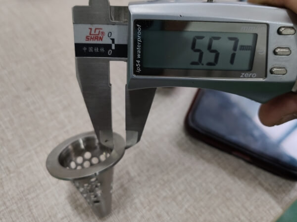 The flange width of the small conical perforated filter element is 5.57 mm.