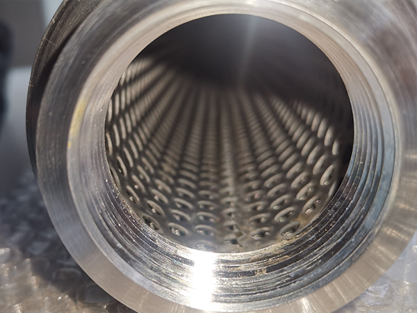 A detail view of inner surface of polymer melt filter element and we can see the perforated tubes.