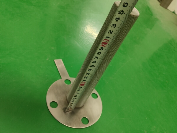 Meter ruler is measuring the length of customized temporary filter and it shoes 25.1 cm.
