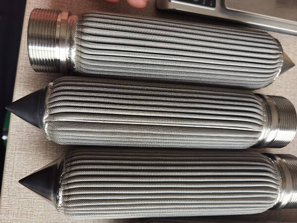 3 short polymer melt filter elements on a wooden box