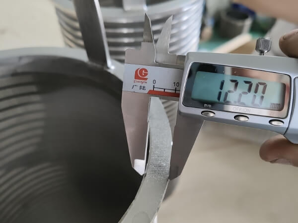 The flange width of the wedge wire screen filter basket, as measured with a caliper, is 12.2 mm.