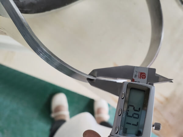 The thickness of the handle on the wedge wire screen filter basket, as measured with a vernier caliper, is 2.97 mm.