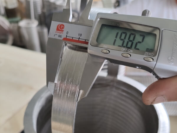The width of the handle on the wedge wire screen filter basket, as measured with a vernier caliper, is 19.82 mm.