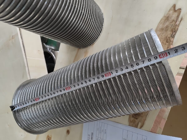 The length of the wedge wire screen filter basket on a wooden crate is 400 mm with a meter rule.